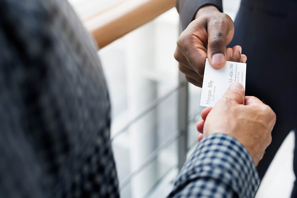 Person handing out their business card